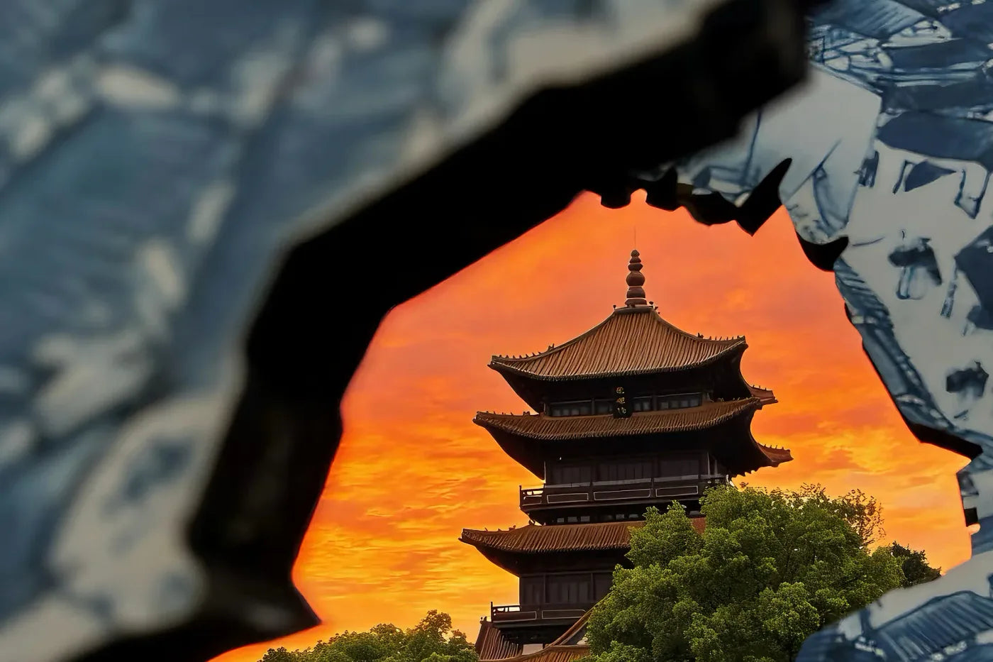 Jingdezhen pagoda seen through a gap in blue-and-white porcelain shards