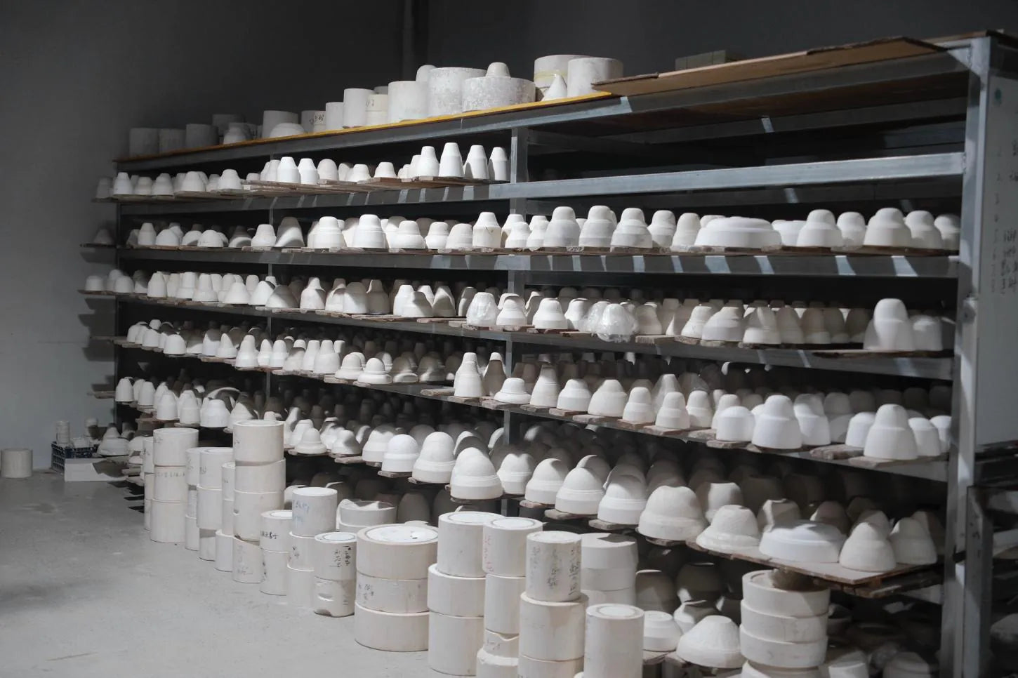 A brush laying colour onto unfired porcelain
