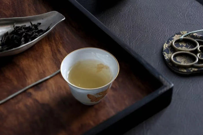 A thin-walled porcelain cup held to the light