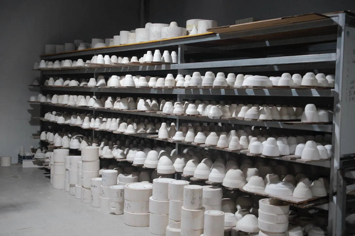 A brush laying colour onto unfired porcelain