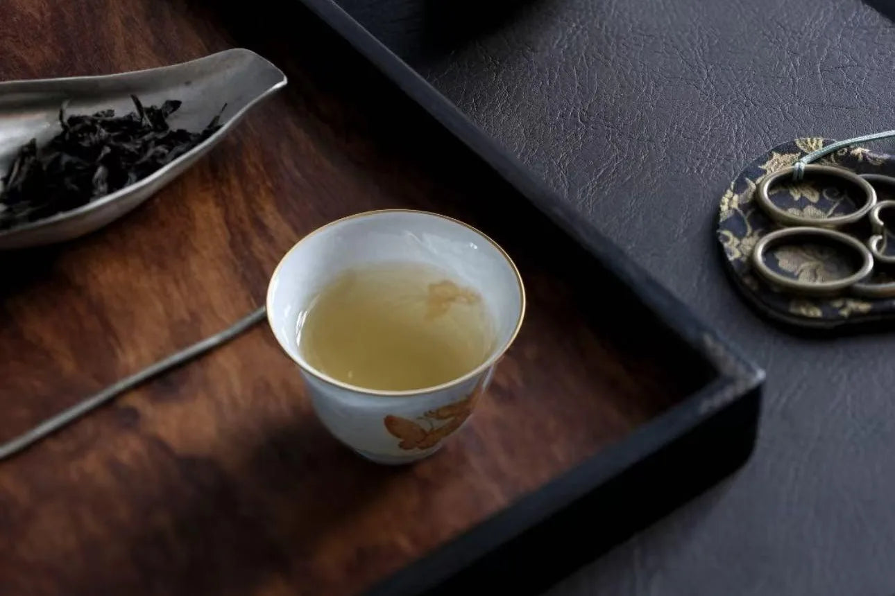 A thin-walled porcelain cup held to the light