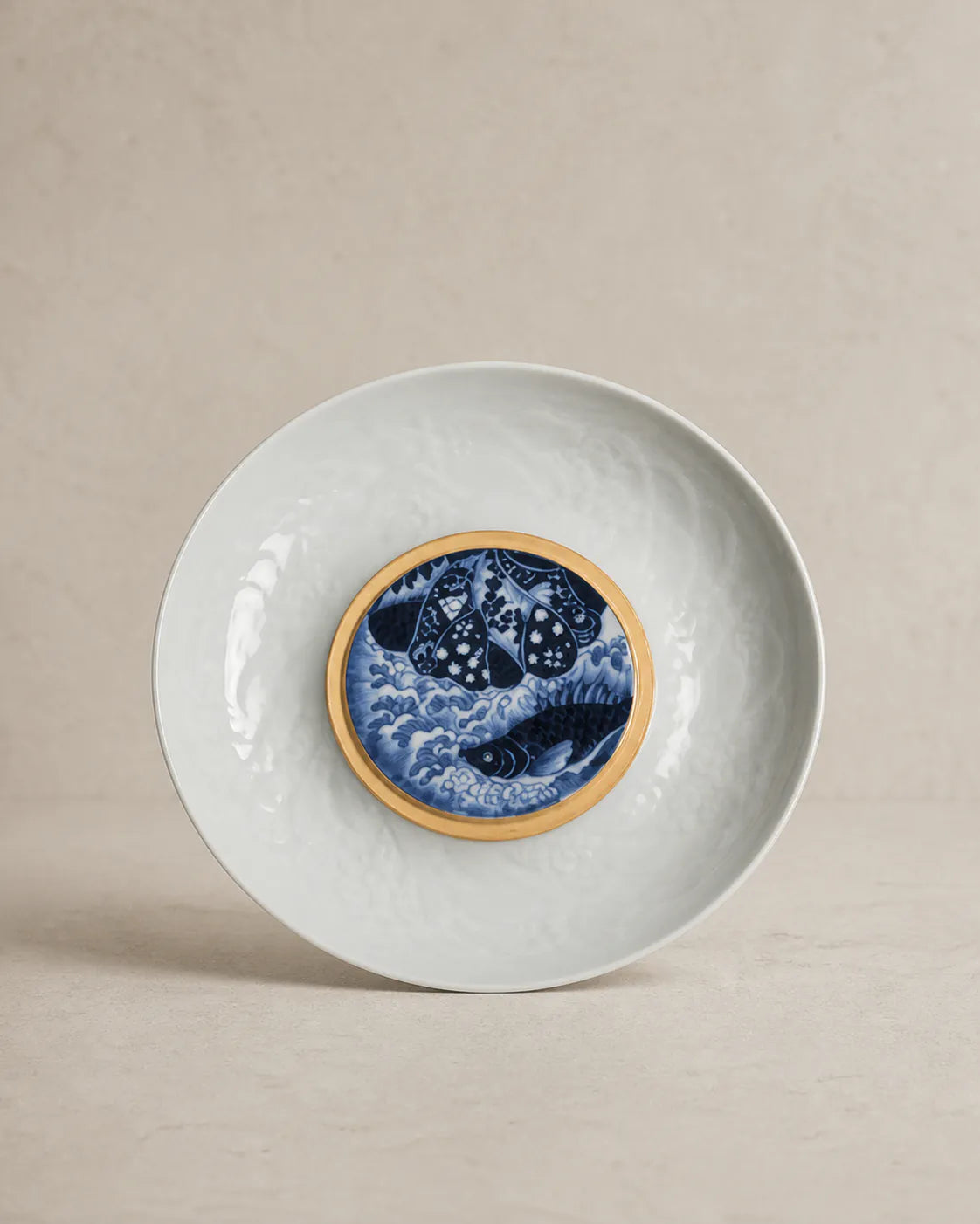 Celadon bowl with gilt-rimmed cobalt medallion of carp and waves